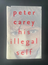 Load image into Gallery viewer, His Illegal Self by Peter Carey: photo of the front cover which shows small cuts and tears on the dust jacket.
