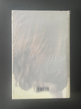 Load image into Gallery viewer, His Illegal Self by Peter Carey: photo of the back cover which shows small cuts and tears on the dust jacket.