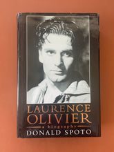 Load image into Gallery viewer, Laurence Olivier by Donald Spoto: photo of the front cover which shows minor scuff marks, and a long tear on each of the top corners which have both been sticky-taped back into place.