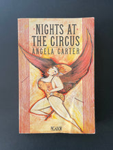 Load image into Gallery viewer, Nights at the Circus by Angela Carter: photo of the front cover which shows a fair amount of creasing and some scuff marks.