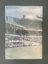 Load image into Gallery viewer, One Hundred Years of Trotting 1877-1977 by Greg Brown: photo of the back cover which shows minor scuff marks along the edges of the dust jacket.