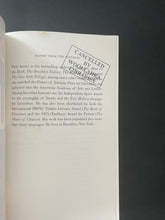 Load image into Gallery viewer, Report from the Interior by Paul Auster: photo of the first page which sows a black library stamp.