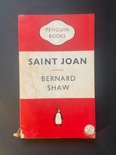 Load image into Gallery viewer, Book cover of Saint Joan by Bernard Shaw from Penguin Books, featuring a red and off-white cover with the Penguin logo at the bottom.
