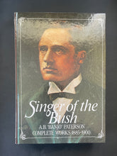 Load image into Gallery viewer, Book cover of 'Singer of the Bush' by A.B. 'Banjo' Paterson with a portrait of the author on a dark background.