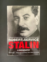 Load image into Gallery viewer, Stalin-A Biography by Robert Service: photo of the front cover which shows minor scuff marks along the edges, and tiny parts of the clear plastic dust jacket jutting out at the edges.