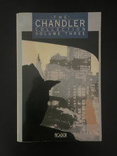 Load image into Gallery viewer, Book cover of 'The Chandler Collection Volume Three' by Raymond Chandler with a cityscape silhouette. The photo shows very minor scuff marks along the edges