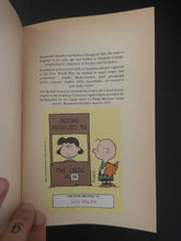 Load image into Gallery viewer, The Chandler Collection-Volume Two by Raymond Chandler: photo of the first page which shows a large Peanuts sticker with the name of a previous owner written along the bottom.