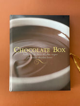Load image into Gallery viewer, The Chocolate Box by Fiona Roberts: photo of the front cover which shows very minor (barely noticeable) scuff marks along the edges.