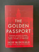 Load image into Gallery viewer, The Golden Passport by Duff McDonald: photo of the front cover which shows very minor scuff marks along the edges.