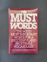 Load image into Gallery viewer, Book cover for 'The Must Words' on a maroon background. Photo shows very minor, tiny, scuff marks along the edges of the dust jacket.