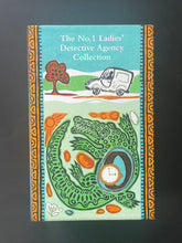 Load image into Gallery viewer, The No. 1 Ladies' Detective Agency Collection by Alexander McCall Smith: photo of the front of the box set which shows a tiny scuff mark on the top-left corner. The box is like new otherwise.