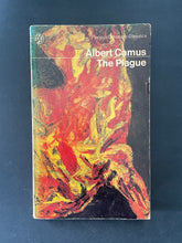 Load image into Gallery viewer, Book cover of 'The Plague' by Albert Camus with abstract art design on a dark background. The photo shows scuff marks and wear along the edges, and a minor tear on the fore-edge.