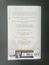 Load image into Gallery viewer, The Rainmaker by John Grisham: photo of the back cover which shows tiny (barely visible) scuff marks.