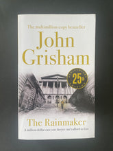 Load image into Gallery viewer, The Rainmaker by John Grisham: photo of the front cover which shows tiny scuff marks along the edges.