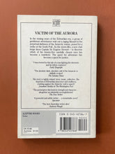 Load image into Gallery viewer, Victim of the Aurora by Thomas Keneally: photo of the back cover which shows minor scuff marks and scratching.