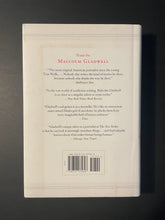 Load image into Gallery viewer, What the Dog Saw and Other Adventures by Malcolm Gladwell: photo of the back cover which shows very minor smudges of discolouring.