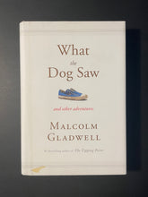 Load image into Gallery viewer, What the Dog Saw and Other Adventures by Malcolm Gladwell: photo of the front cover which shows a small patch of discolouring on the bottom left-hand side.