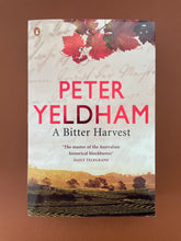 Load image into Gallery viewer, A Bitter Harvest by Peter Yeldham: photo of the front cover which shows very minor (barely visible) scuff marks along the edges.