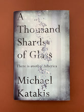 Load image into Gallery viewer, A Thousand Shards of Glass by Michael Katakis: photo of front cover which shows minor scuff marks along the edges.