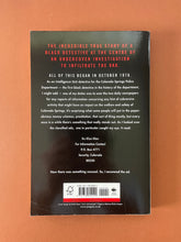 Load image into Gallery viewer, Black Klansman by Ron Stallworth: photo of the back cover which shows minor creasing on the bottom-left corner.