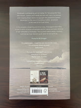 Load image into Gallery viewer, Boyhood Island by Karl Ove Knausgaard book: photo of the back cover. There is a very minor scuff mark on the bottom-left corner and a minor scuff mark just below and to the right of the barcode box.