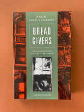 Load image into Gallery viewer, Bread Givers-A Novel by Anzia Yezierska: photo of the front cover which shows creasing on the top-right corner.