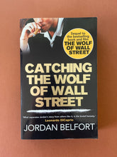 Load image into Gallery viewer, Catching the Wolf of Wall Street by Jordan Belfort: photo of the front cover which shows very minor scuff marks along the edges.