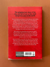 Load image into Gallery viewer, El Jefe-The Stalking of Chapo Guzman by Alan Feuer: photo of the back cover which shows very minor scuff marks along the edges, and a small patch of laminating that has come unstuck on the bottom-left corner.