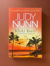 Load image into Gallery viewer, Khaki Towns by Judy Nunn: photo of the front cover which shows creasing on the bottom-half of the cover.