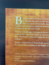 Load image into Gallery viewer, Mr Darwin's Shooter by Roger McDonald book: photo of creasing on the top-left corner of the back cover.