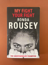 Load image into Gallery viewer, My Fight Your Fight by Ronda Rousey: photo of the front cover which shows very minor scuff marks along the edges, and creasing near the spine and on the top-right corner.