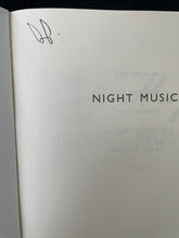 Load image into Gallery viewer, Night Music by Jojo Moyes: photo of the title page which shows the initials of a previous owner written in black pen on the top-left corner.