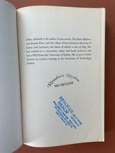 Load image into Gallery viewer, The Household Guide to Dying by Debra Adelaide: photo of the first page of the book which shows two stamps, one in black ink, the other in blue.