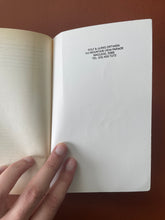 Load image into Gallery viewer, The Kitchen God's Wife by Amy Tan: photo of the inside of the back cover which has a black stamp at the top that reads: ROLF & ULRIKE ORTWEIN, 142 MOUNTAIN VIEW PARADE, MACLEOD, 3085, TEL: (03) 459 7272