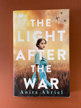 Load image into Gallery viewer, The Light After the War by Anita Abriel: photo of the front cover which shows very minor scuff marks along the edges.