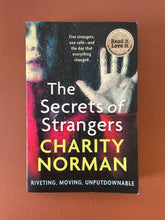 Load image into Gallery viewer, The Secrets of Strangers by Charity Norman: photo of the front cover which shows very minor scuff marks along the edges.