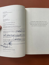 Load image into Gallery viewer, The Subjugate by Amanda Bridgeman: photo of the copyright page which shows the texta that has seeped through the previous page.