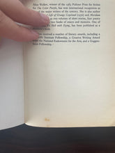 Load image into Gallery viewer, The Temple of My Familiar by Alice Walker book: photo of a blotch of discolouring on the bottom of the first page.