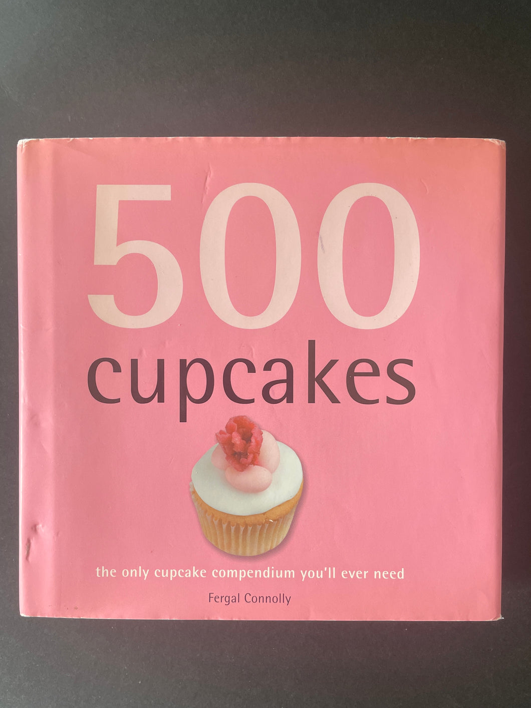 500 Cupcakes by Fergal Connolly: photo of the front cover which shows scuff marks on the dust jacket.