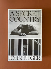 Load image into Gallery viewer, A Secret Country by John Pilger: photo of the front cover which shows very minor scuff marks along the edges of the dust jacket.
