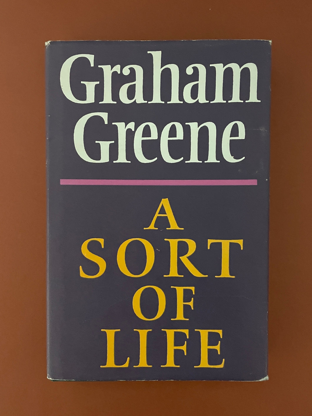 A Sort of Life by Graham Greene: photo of the front cover which shows minor scuff marks along the edges of the dust jacket.