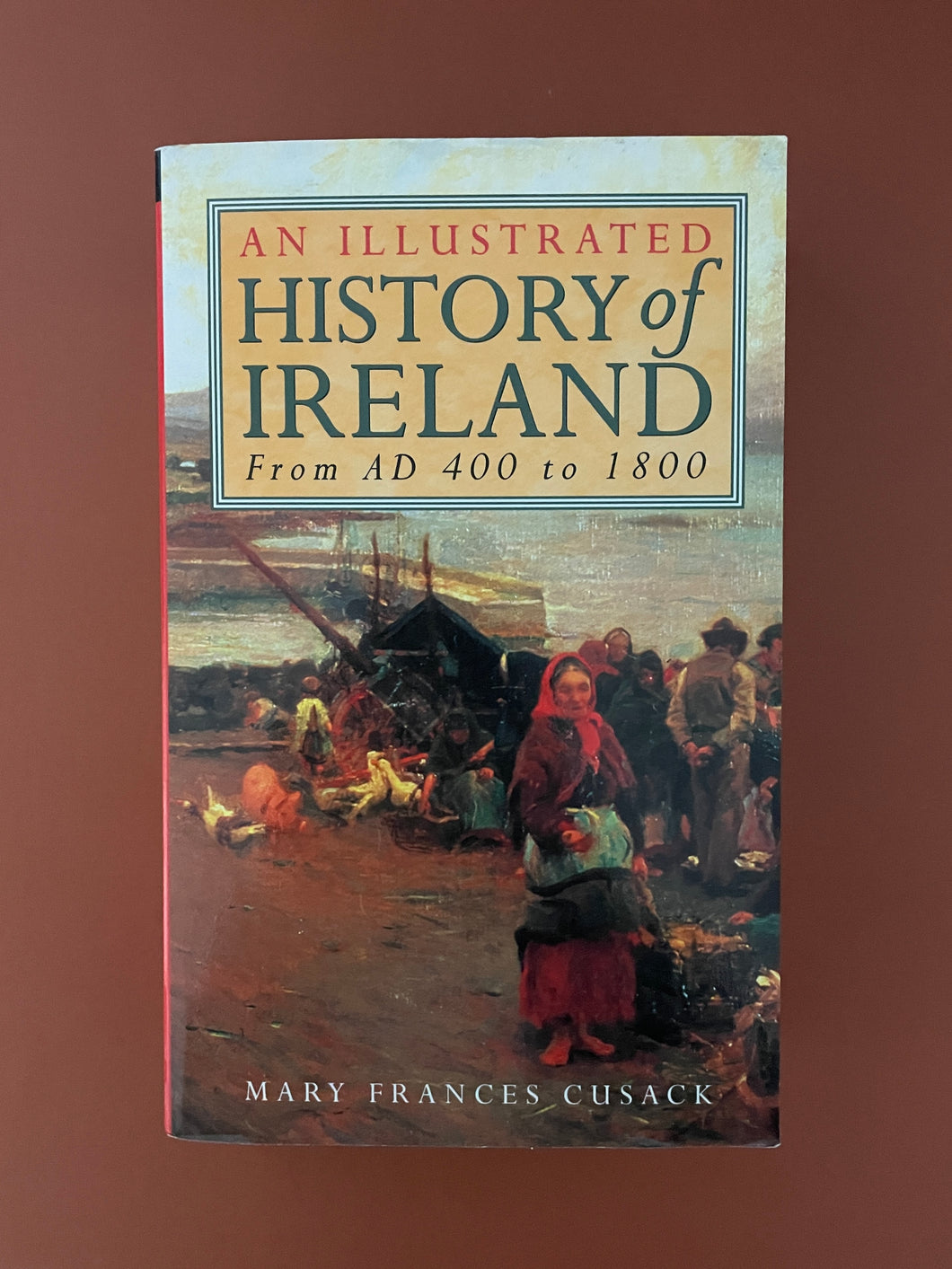 An Illustrated History of Ireland-From AD 400 to 1800 by Mary Frances Cusack: photo of the front cover which shows very minor scuff marks along the edges, and very minor scratching.