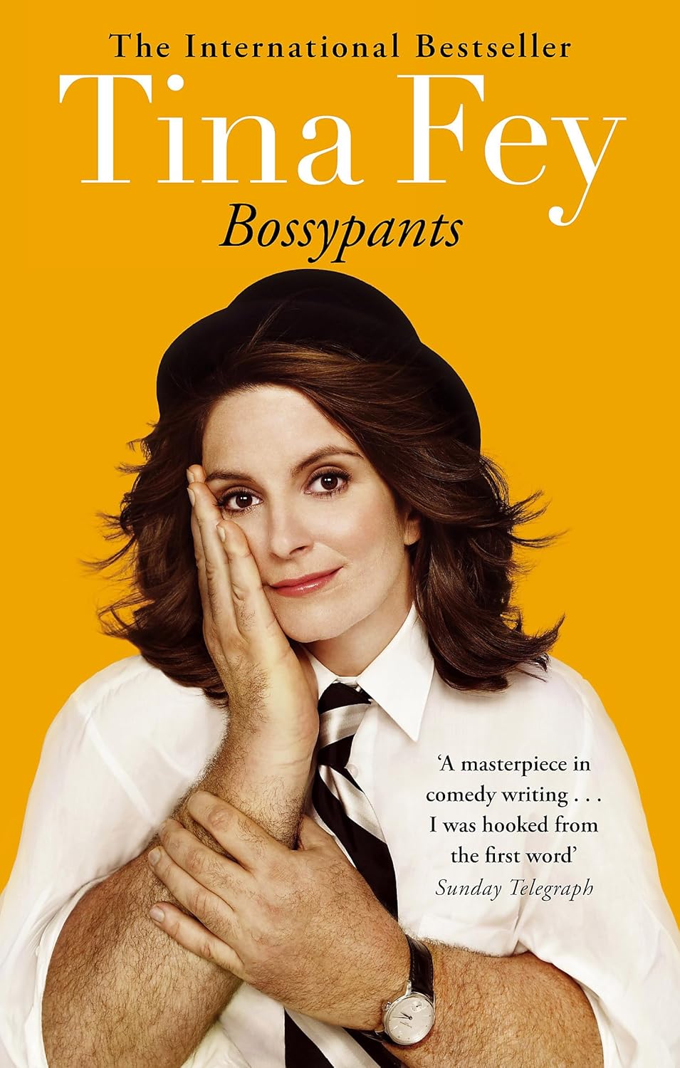 Cover of 'Bossypants' by Tina Fey with a picture of Tina Fey's head on a man's body wearing a white shirt and tie on a yellow background.