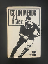Load image into Gallery viewer, Book cover of &#39;All Black&#39; by Colin Meads with a black and white illustration of a rugby player on a dark background. Photo shows creasing and scuff marks along the edges of the dust jacket.
