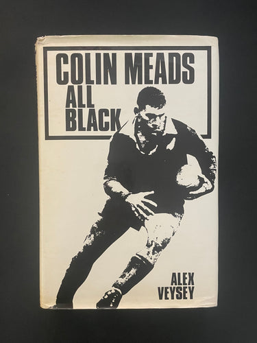 Book cover of 'All Black' by Colin Meads with a black and white illustration of a rugby player on a dark background. Photo shows creasing and scuff marks along the edges of the dust jacket.