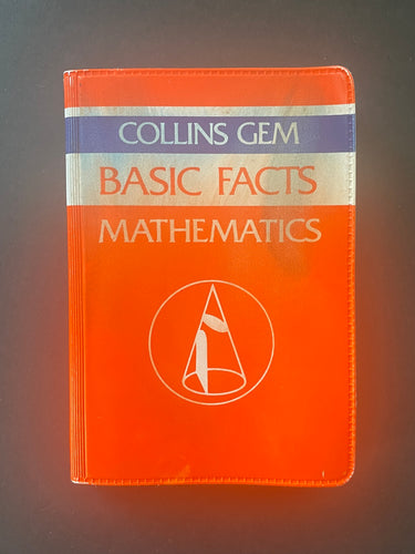 Gem Basic Facts Mathematics by Peter Clamp: photo of front cover which shows a minor crease on the top-right corner, and dark smudges on the top half of the cover.