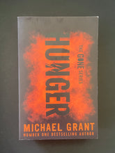 Load image into Gallery viewer, Hunger by Michael Grant: photo of the front cover which shows very, very minor scuff marks along the edges.
