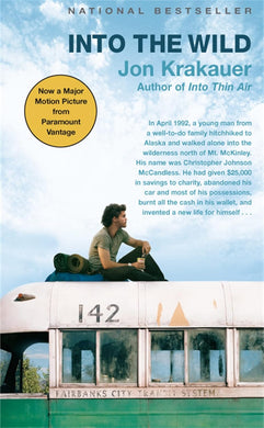 Book cover of 'Into the Wild' by Jon Krakauer with a person sitting on a train car.