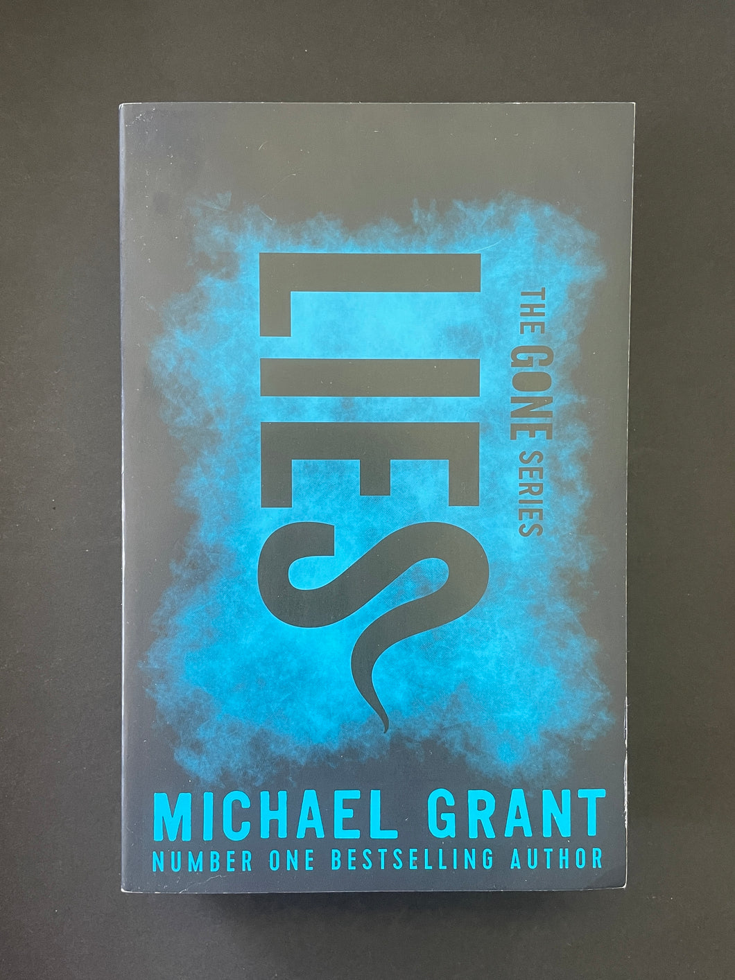 Lies by Michael Grant: photo of the front cover which shows very, very minor scuff marks along the edges.