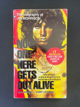 Load image into Gallery viewer, Book cover of &#39;No One Here Gets Out Alive&#39; by Jerry Hopkins, &amp; Danny Sugerman on a dark background. Photo of the front cover which shows obvious creasing and scuff marks.
